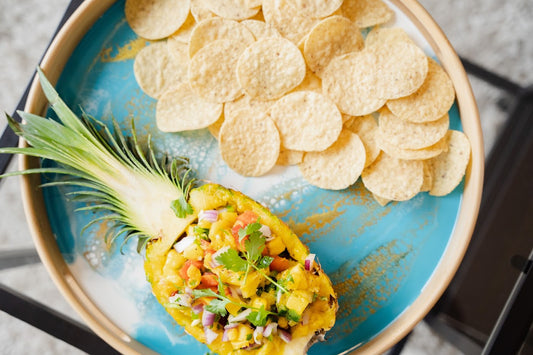 mango pineapple salsa served on a teal resin bamboo serving tray