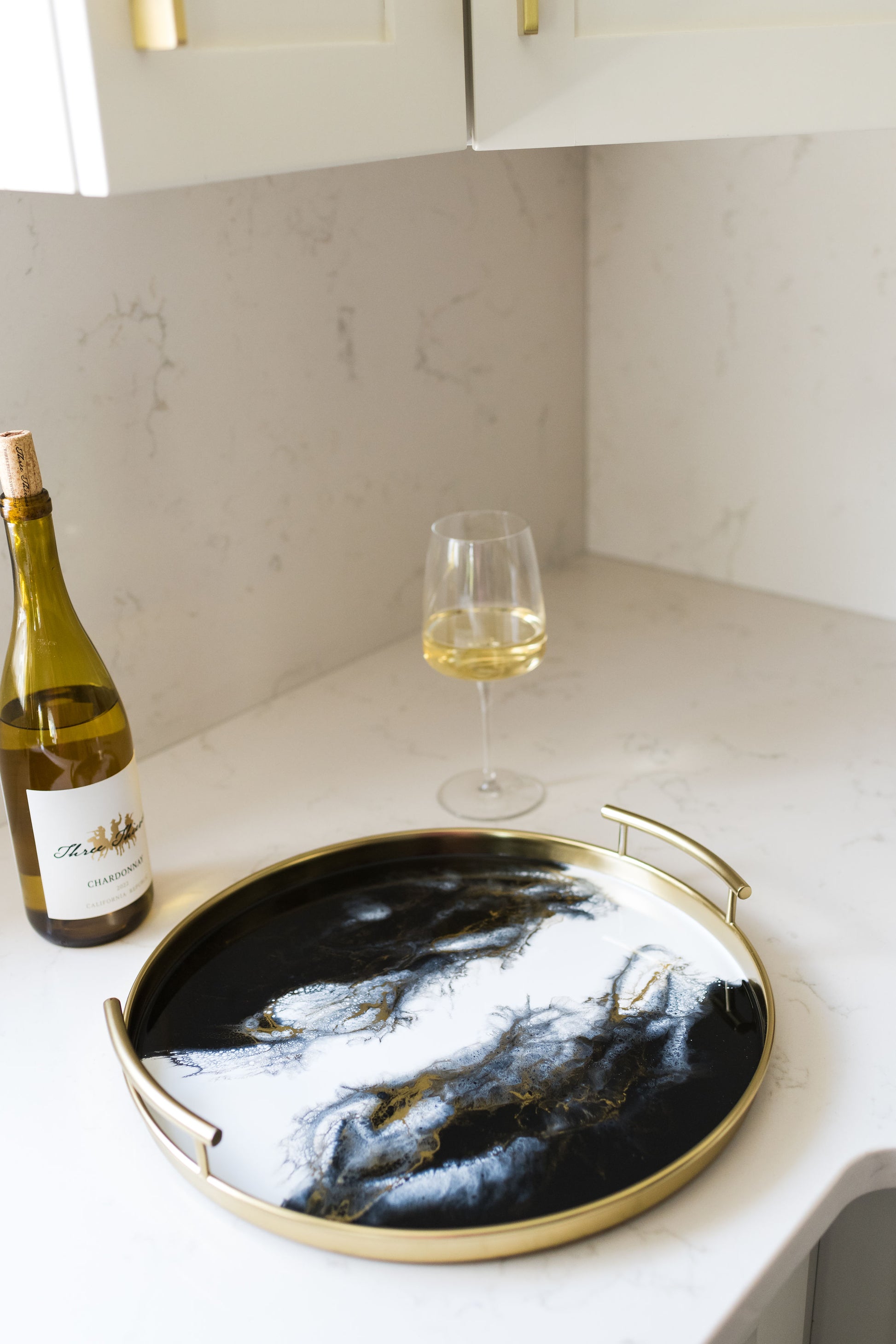 gold round metal tray accented with resin