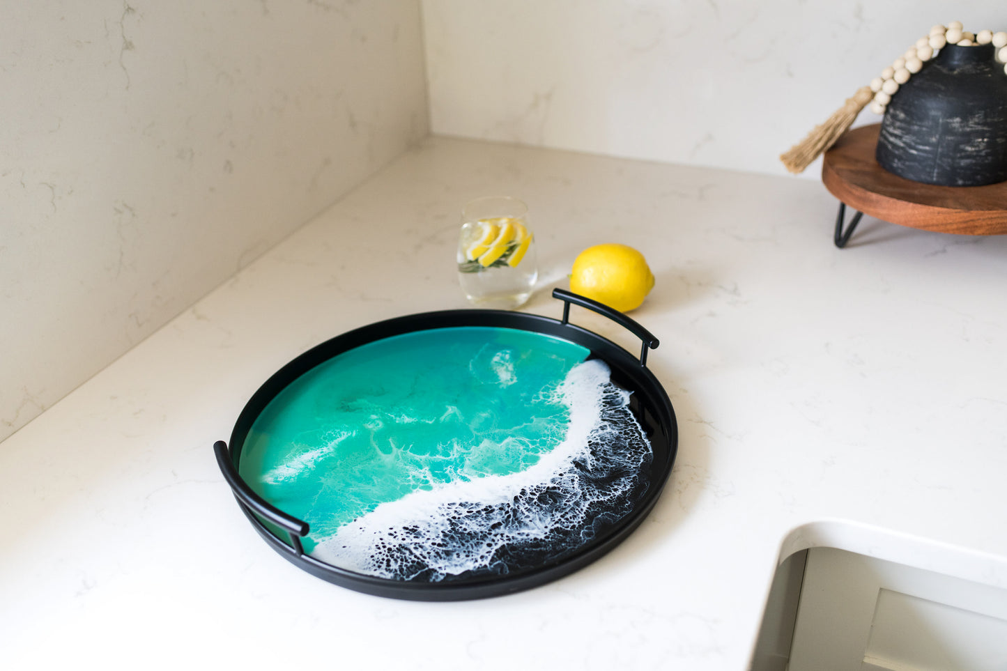 black round metal tray accented with resin