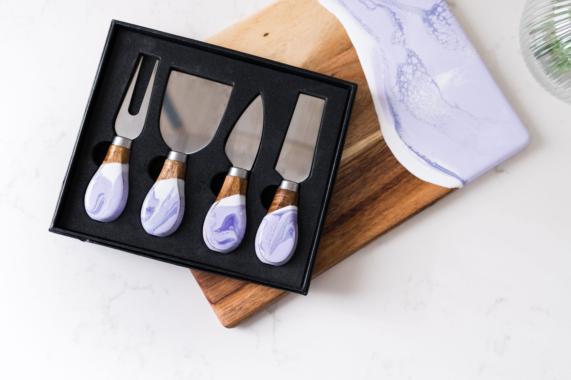 resin cheese knives sitting on a date night board