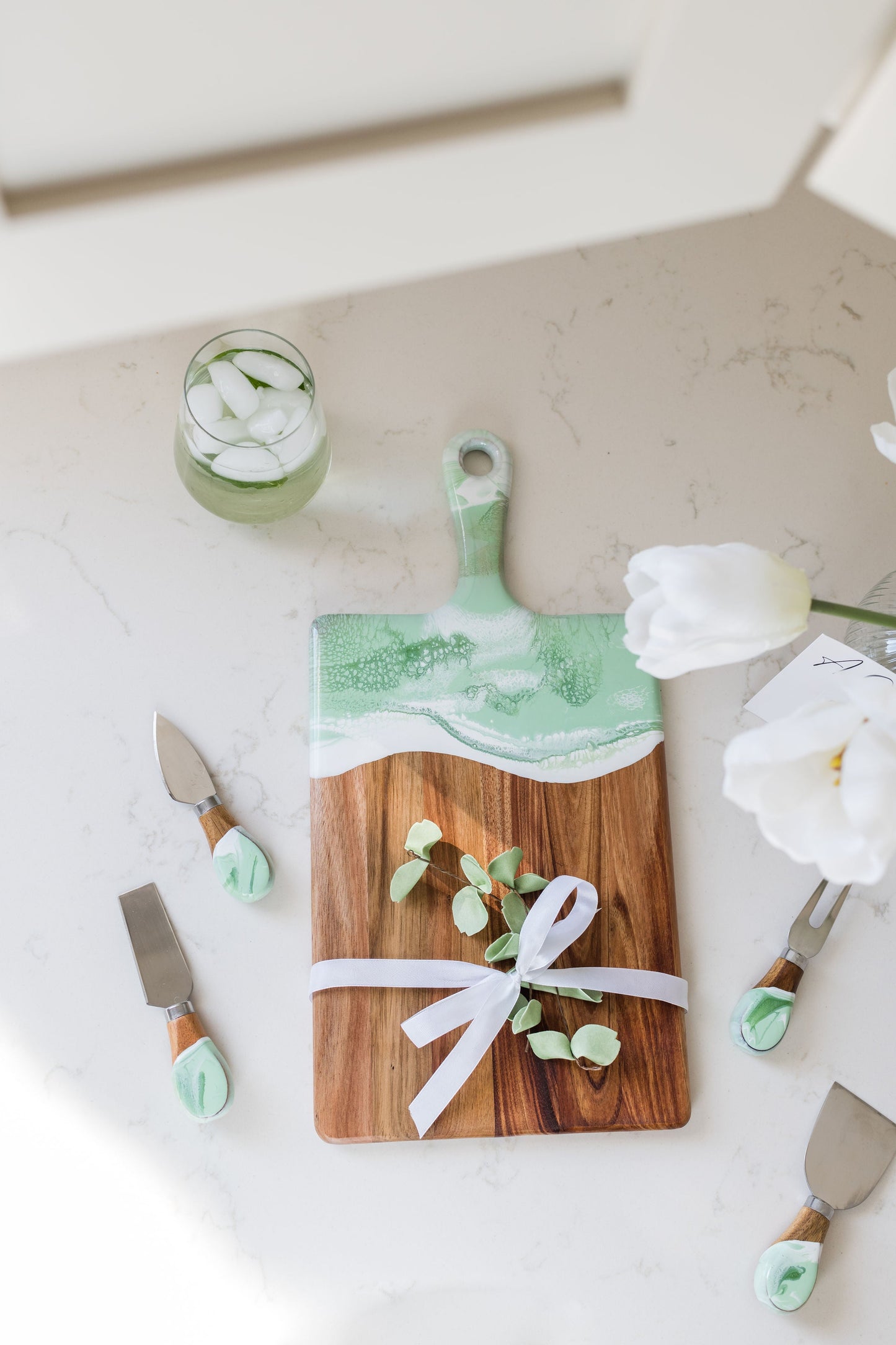 medium mojito board with matching cheese knives sitting on a kitchen counter