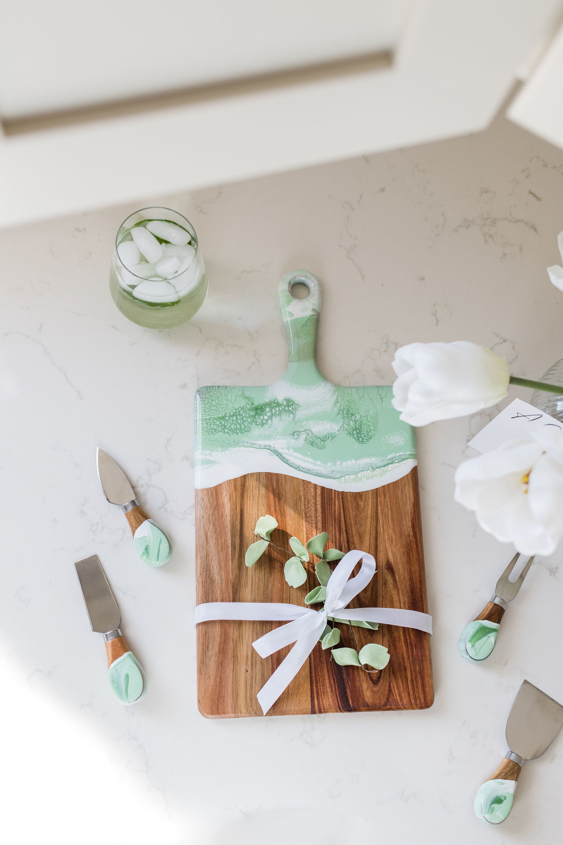 medium mojito board with matching cheese knives sitting on a kitchen counter