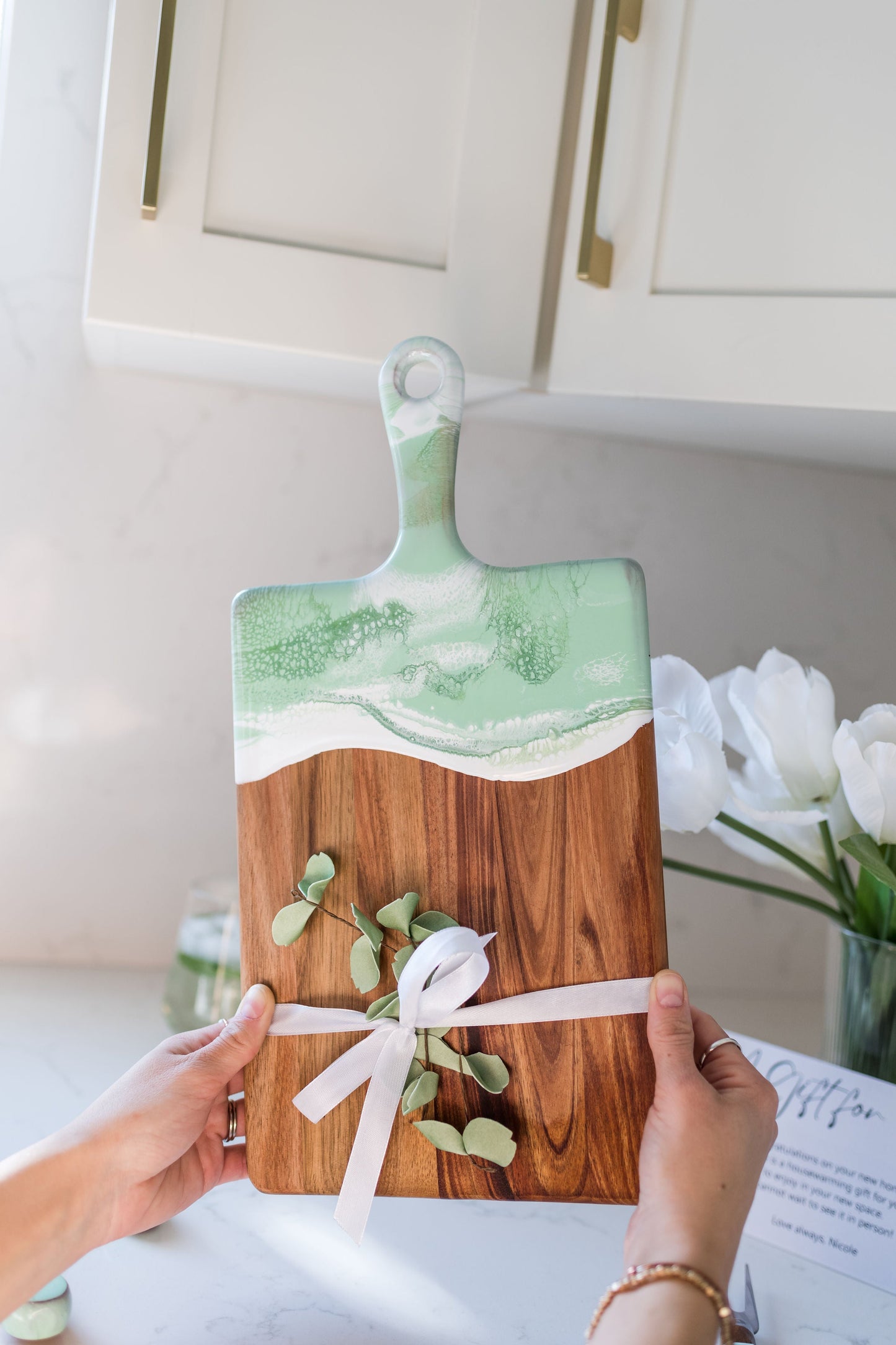 Medium mojito cheese board being held over a kitchen counter