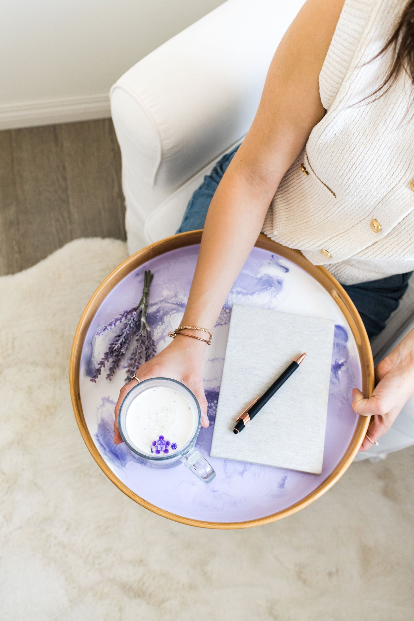 Lavender bamboo tray with a latte being held on top of it