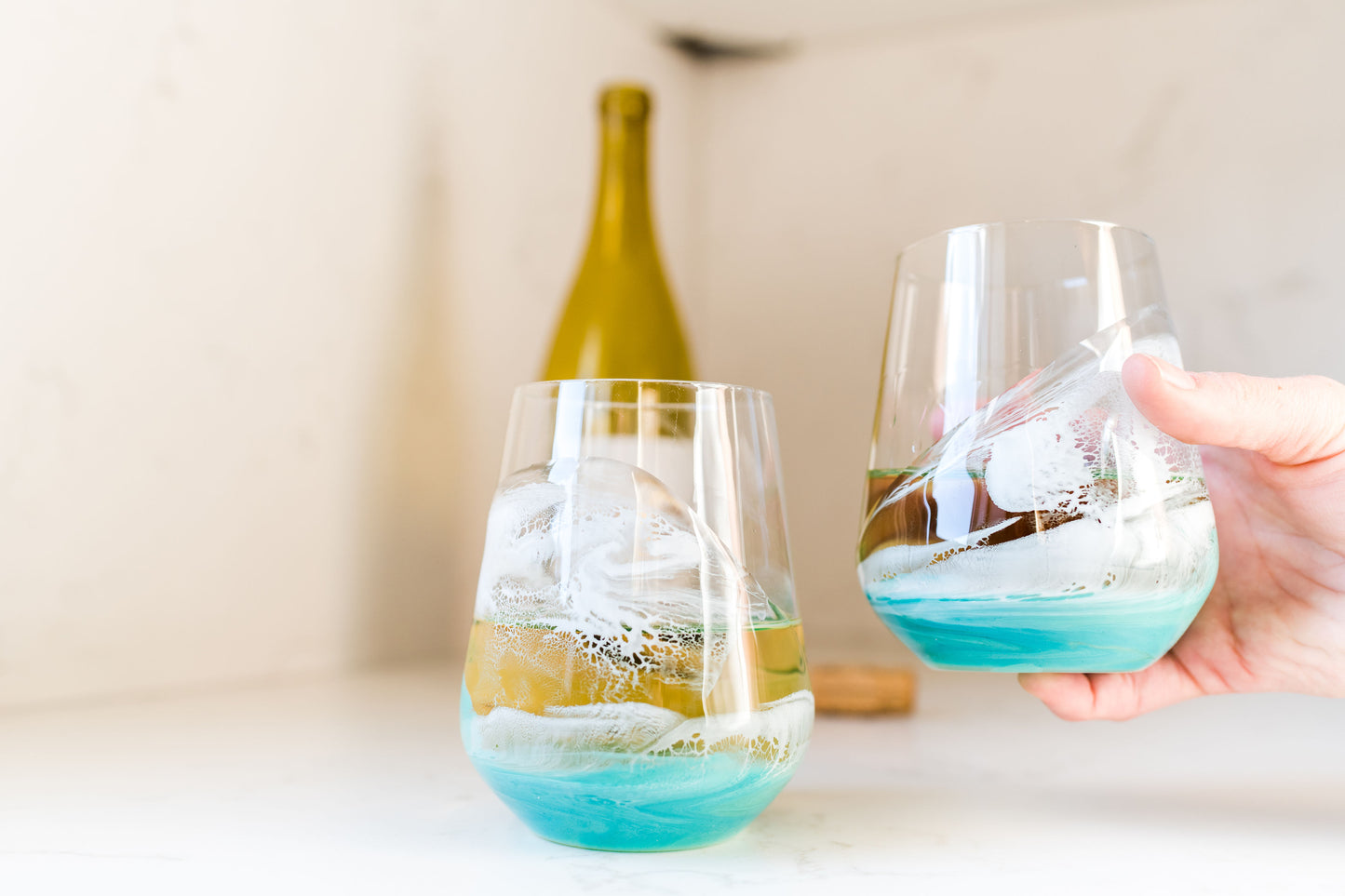 Caribbean Wine Glasses on kitchen counter, one held