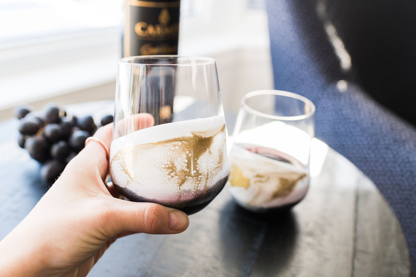 Onyx wine glasses held aboce coffee table