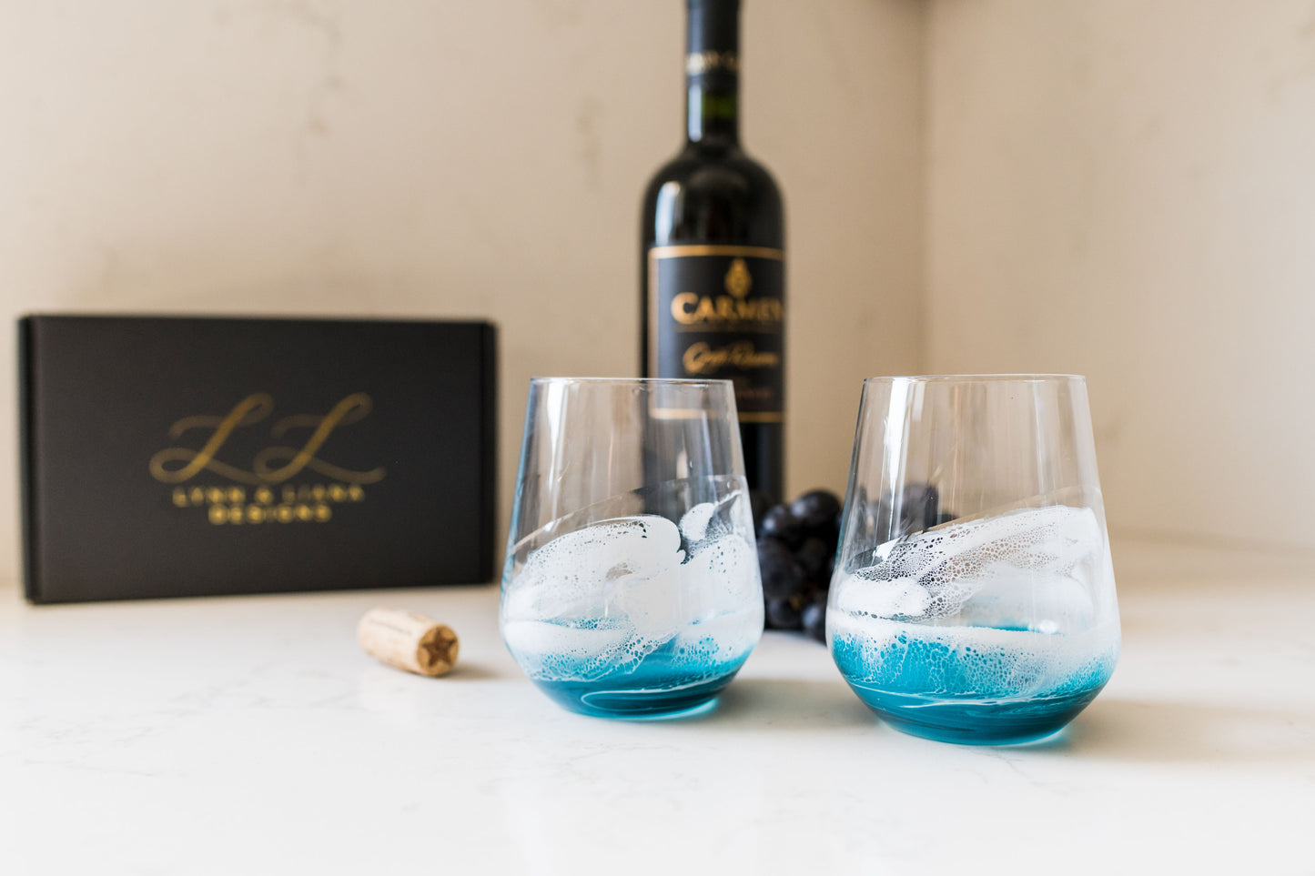 Ocean wine glasses on kitchen counter with giftbox and wine bottle in background