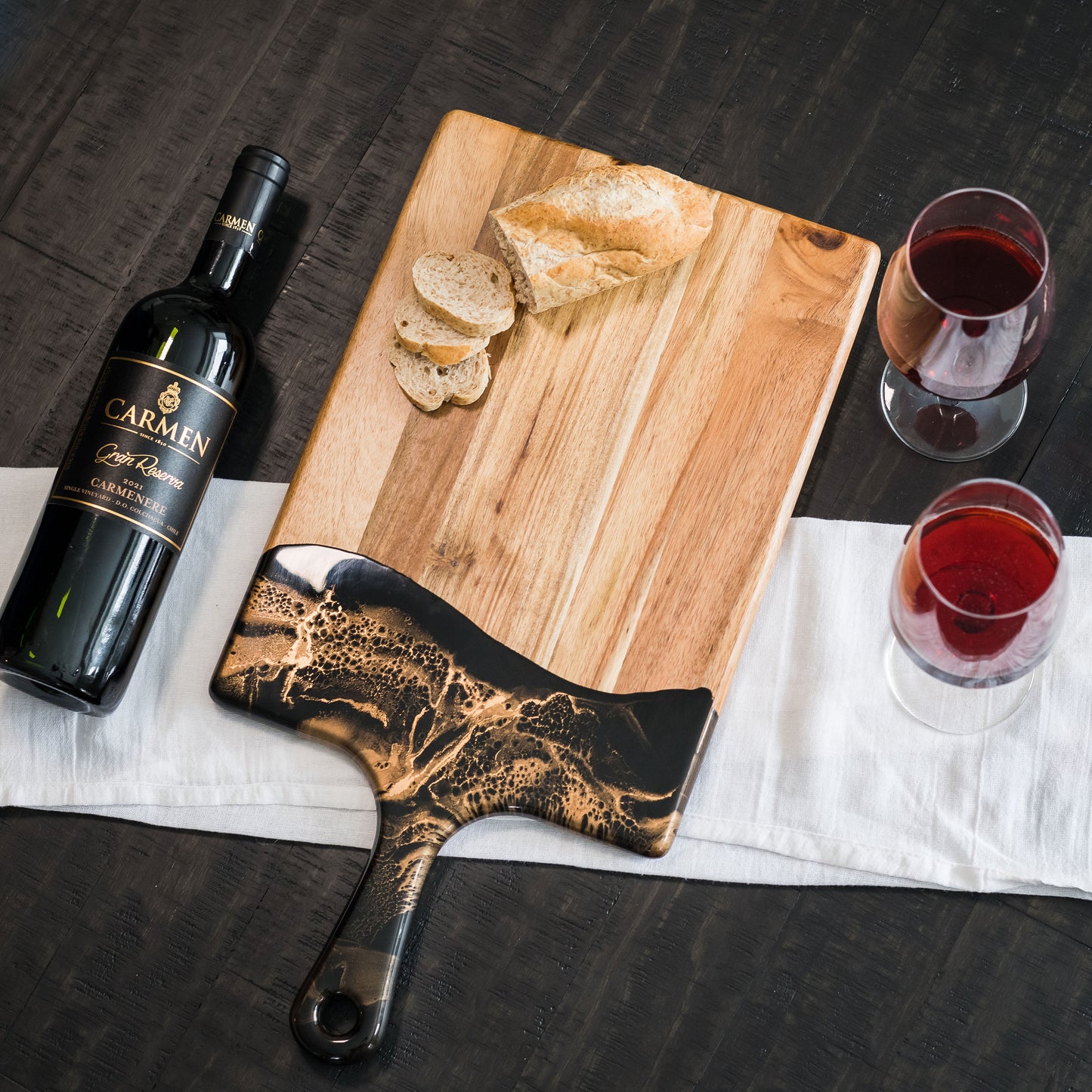 large acacia cheese board accented with resin
