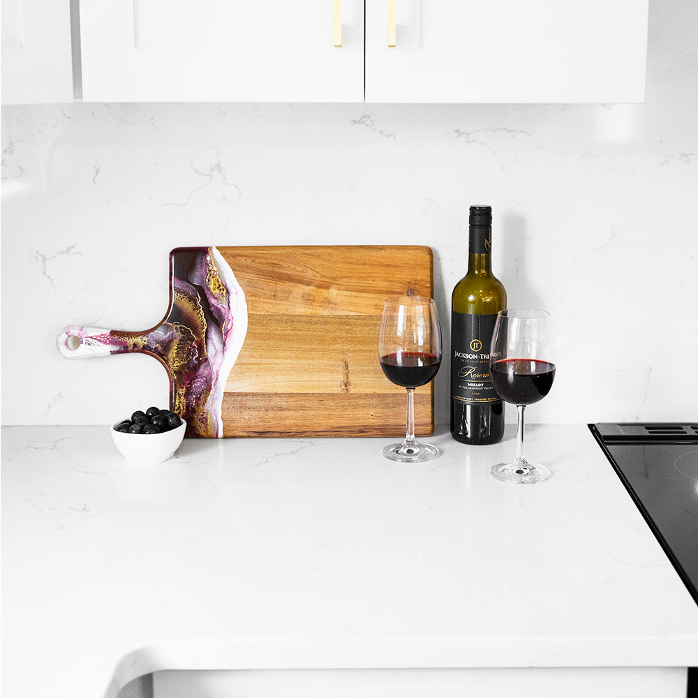 large acacia cheese board accented with resin