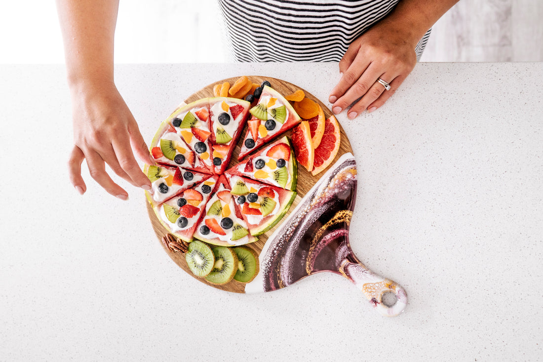 watermelon pizza served on a round resin cheese board