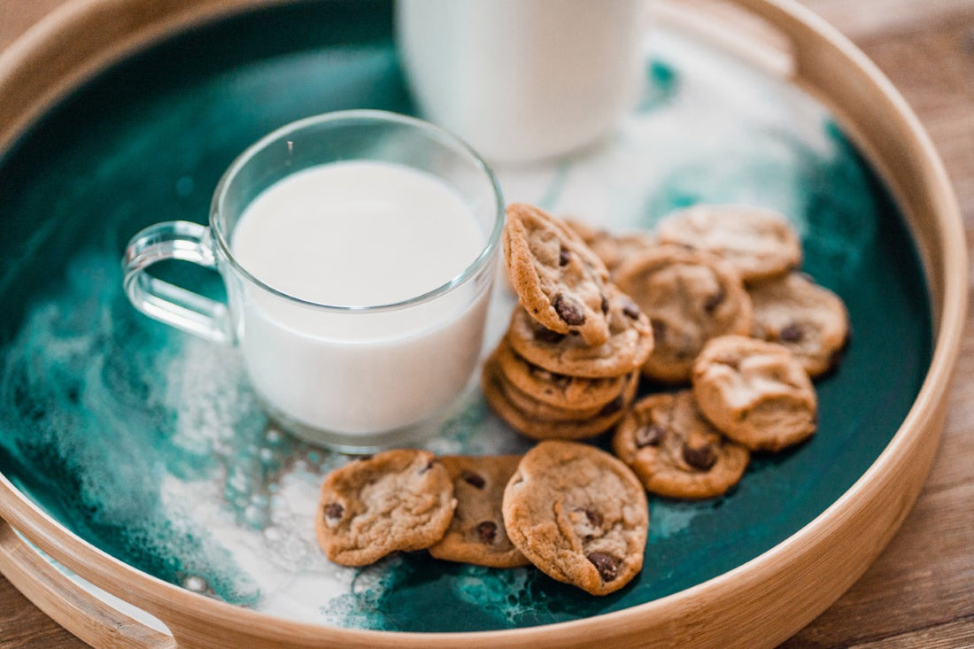 chocolate chip cookies served with milk on resin bamboo serving tray