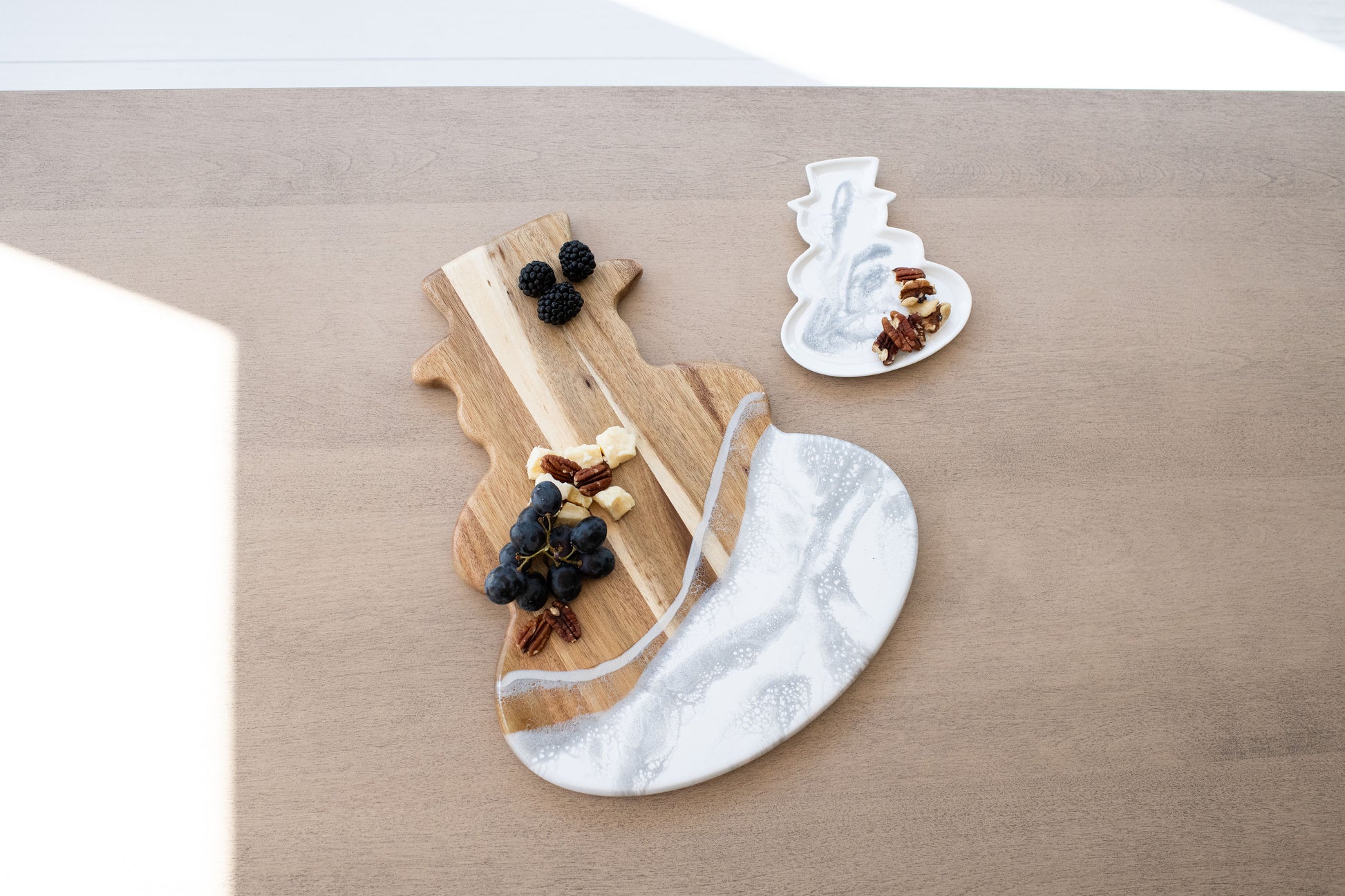 silver metallic resin design snowman board and matching ceramic tray on the kitchen counter with food items displayed on them 