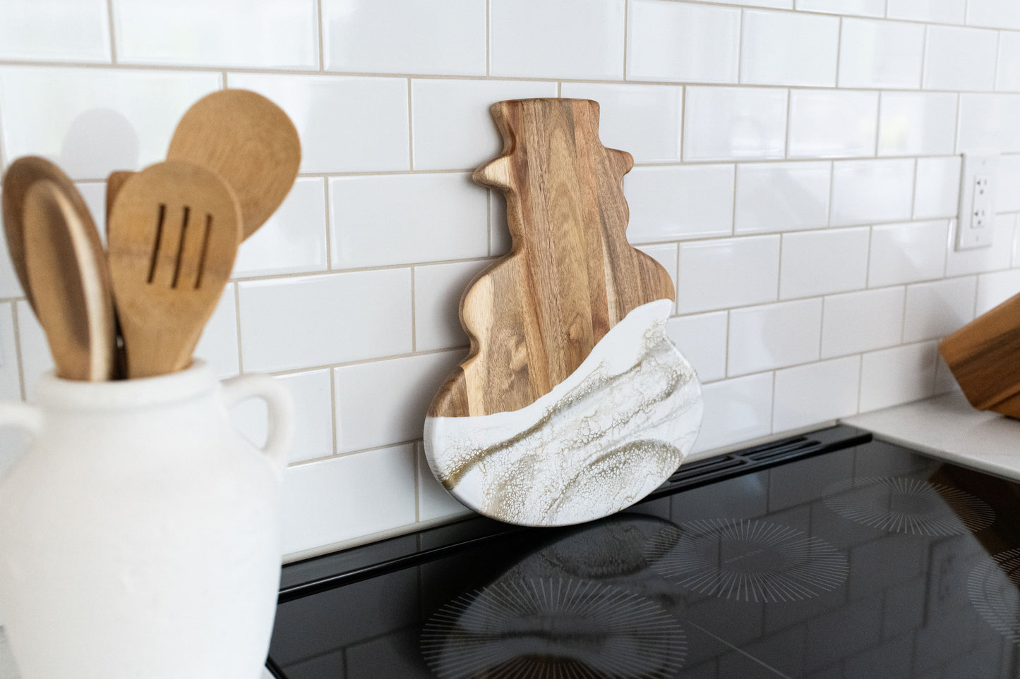Gold Quartz snowman board against a white kitchen back splash 