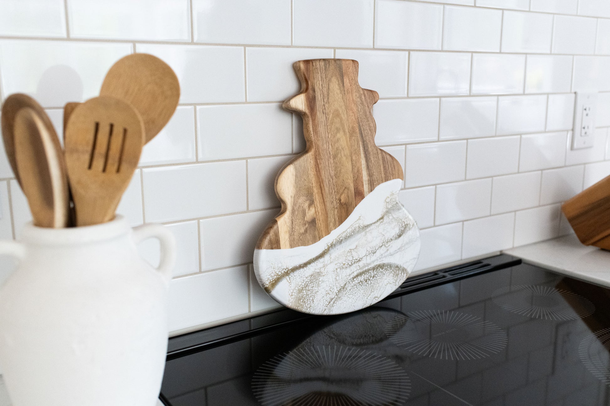 Gold Quartz snowman board against a white kitchen back splash 