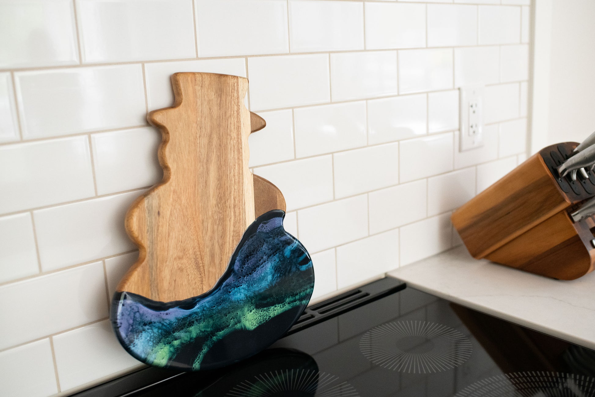 northern lights snowman board against a white kitchen back splash 