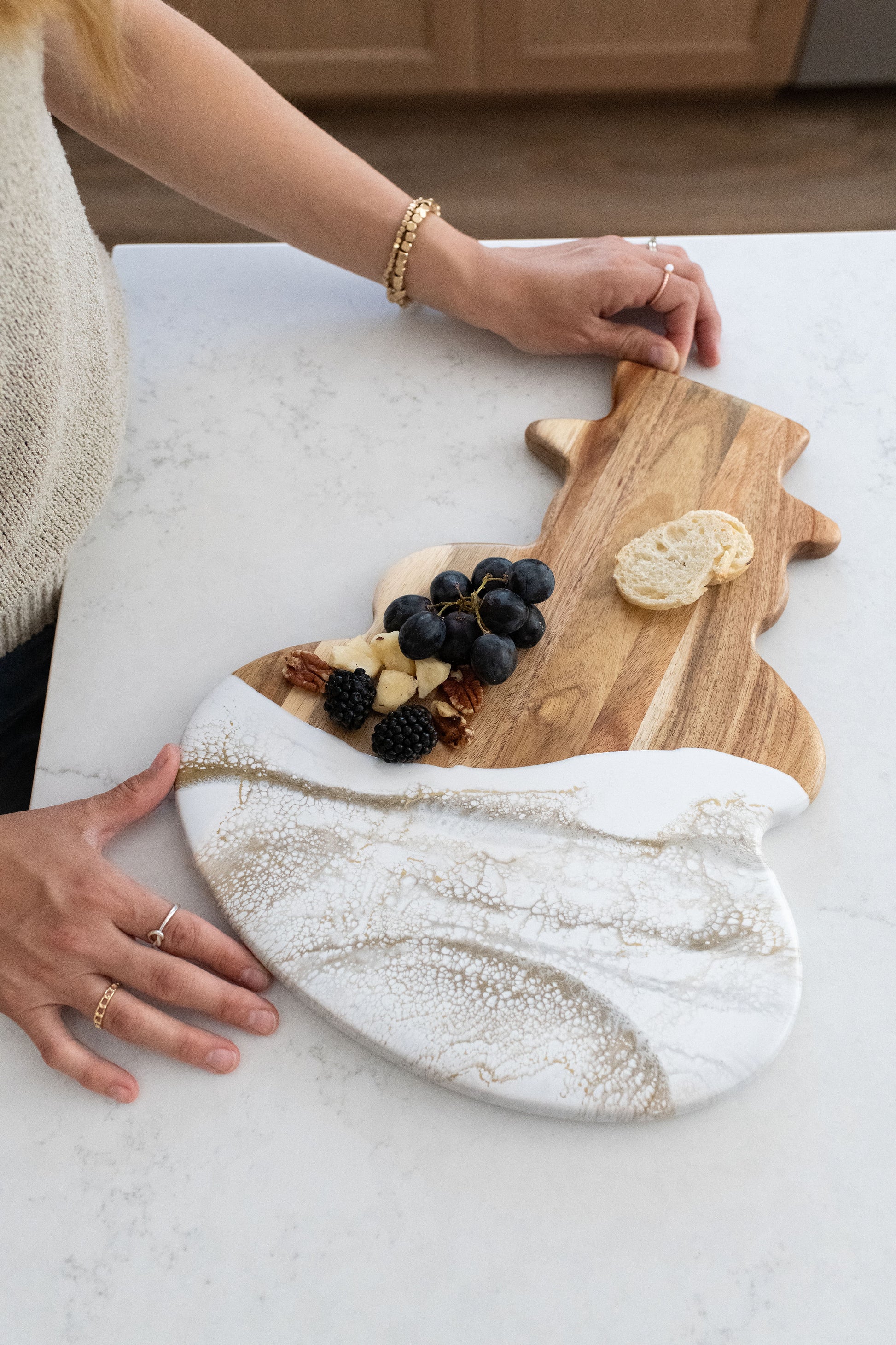 hands holding a gold quartz snowman board 