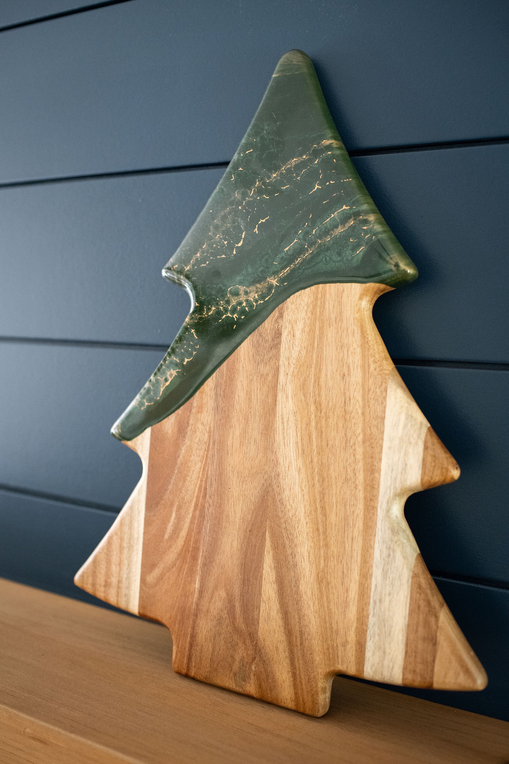jade Christmas tree board on a wooden shelf 