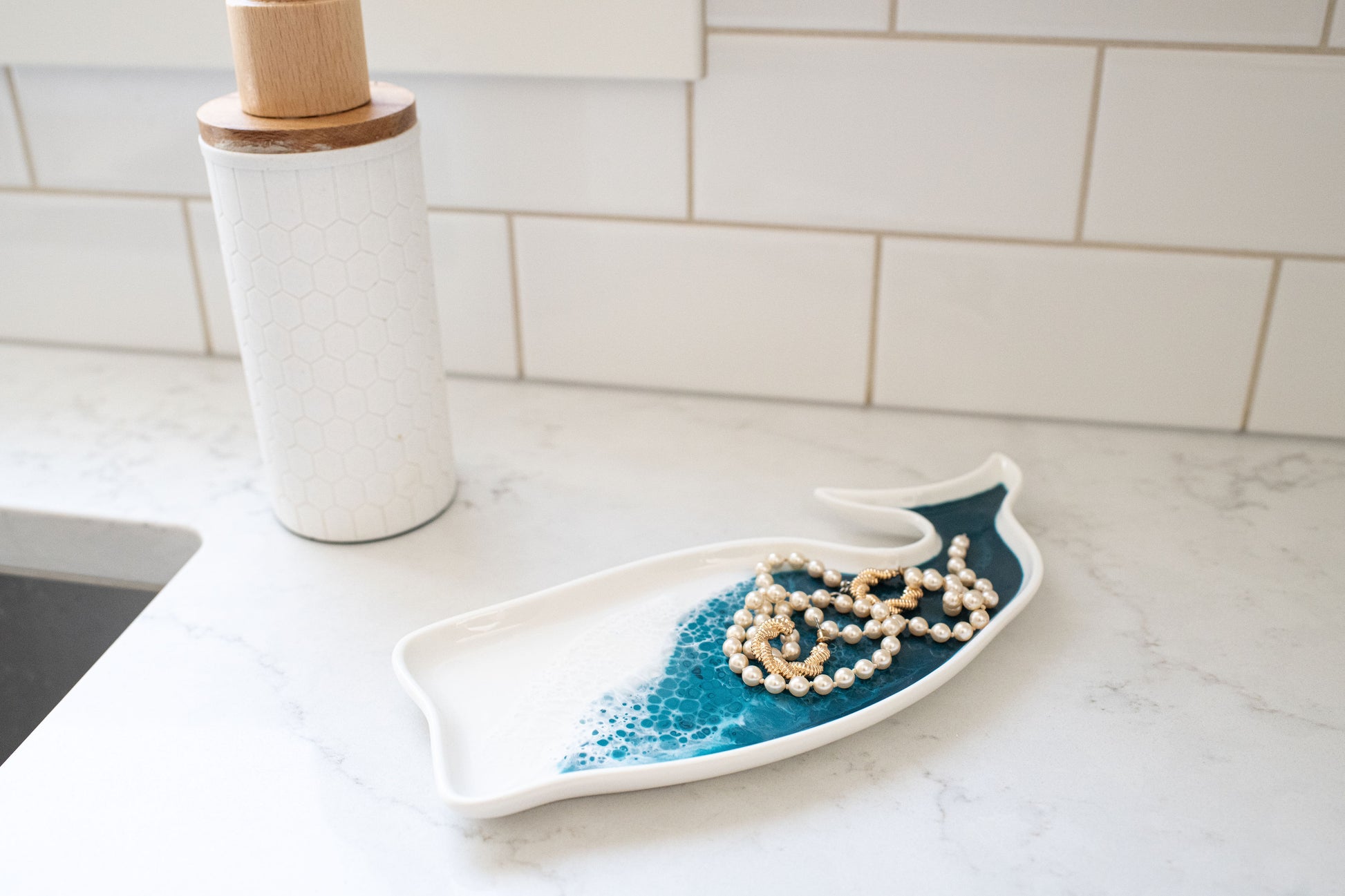 ocean vibes whale ceramic tray on counter with jewelry on it 