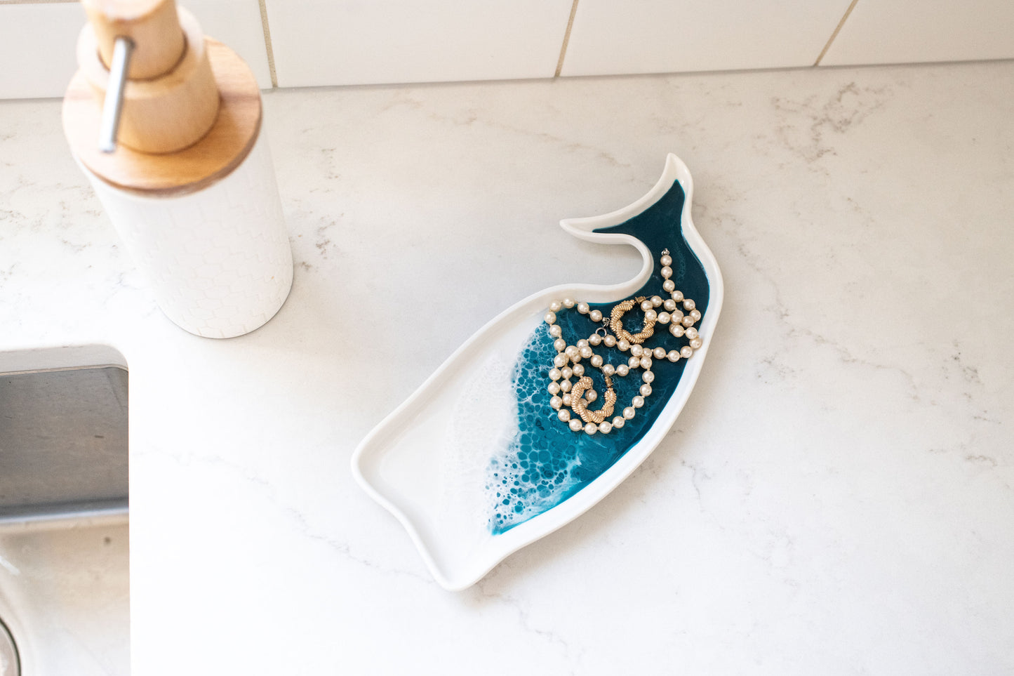 ocean vibes whale ceramic tray with jewelry on it 