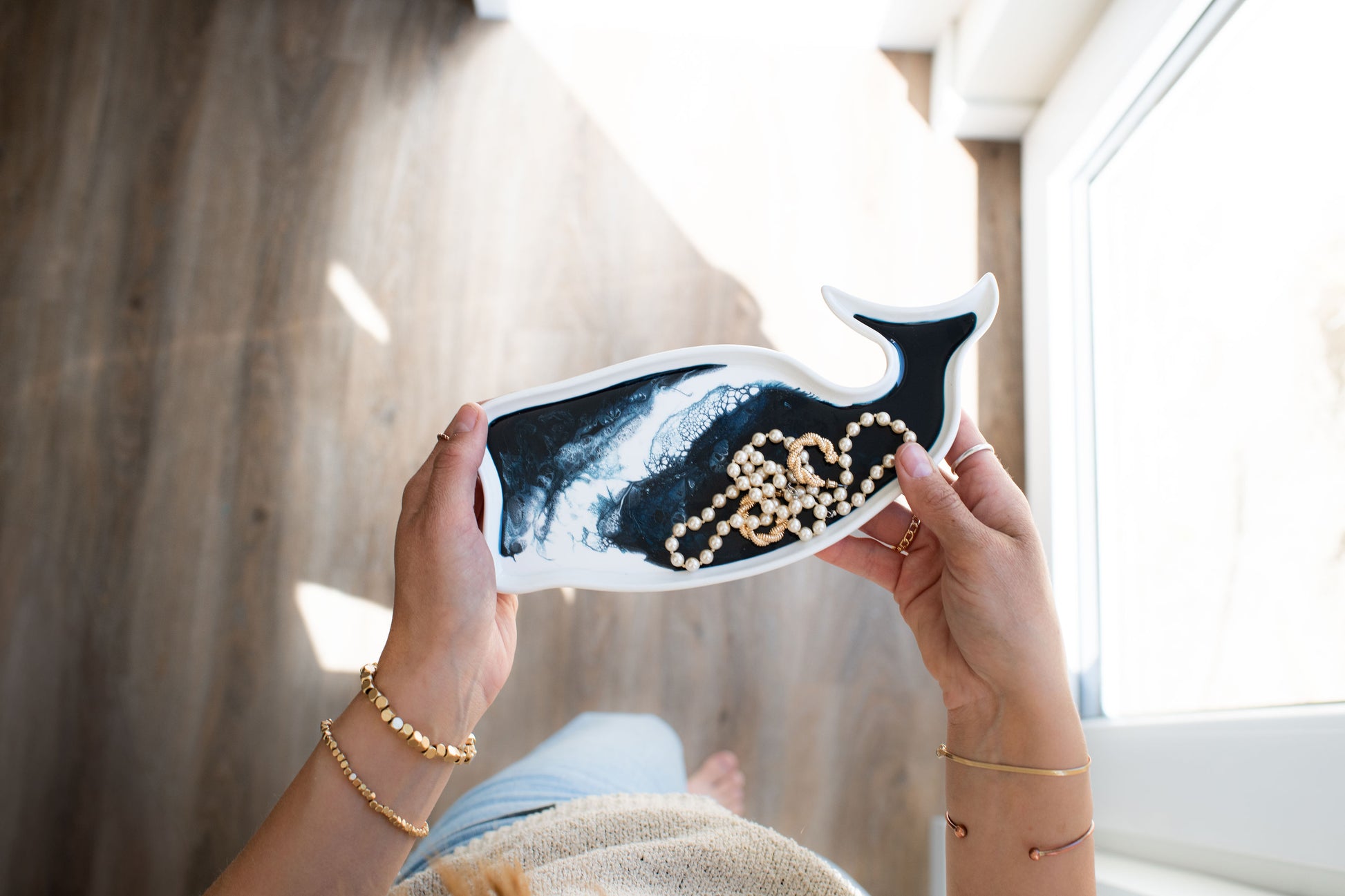 hands holding the navy white whale ceramic tray 
