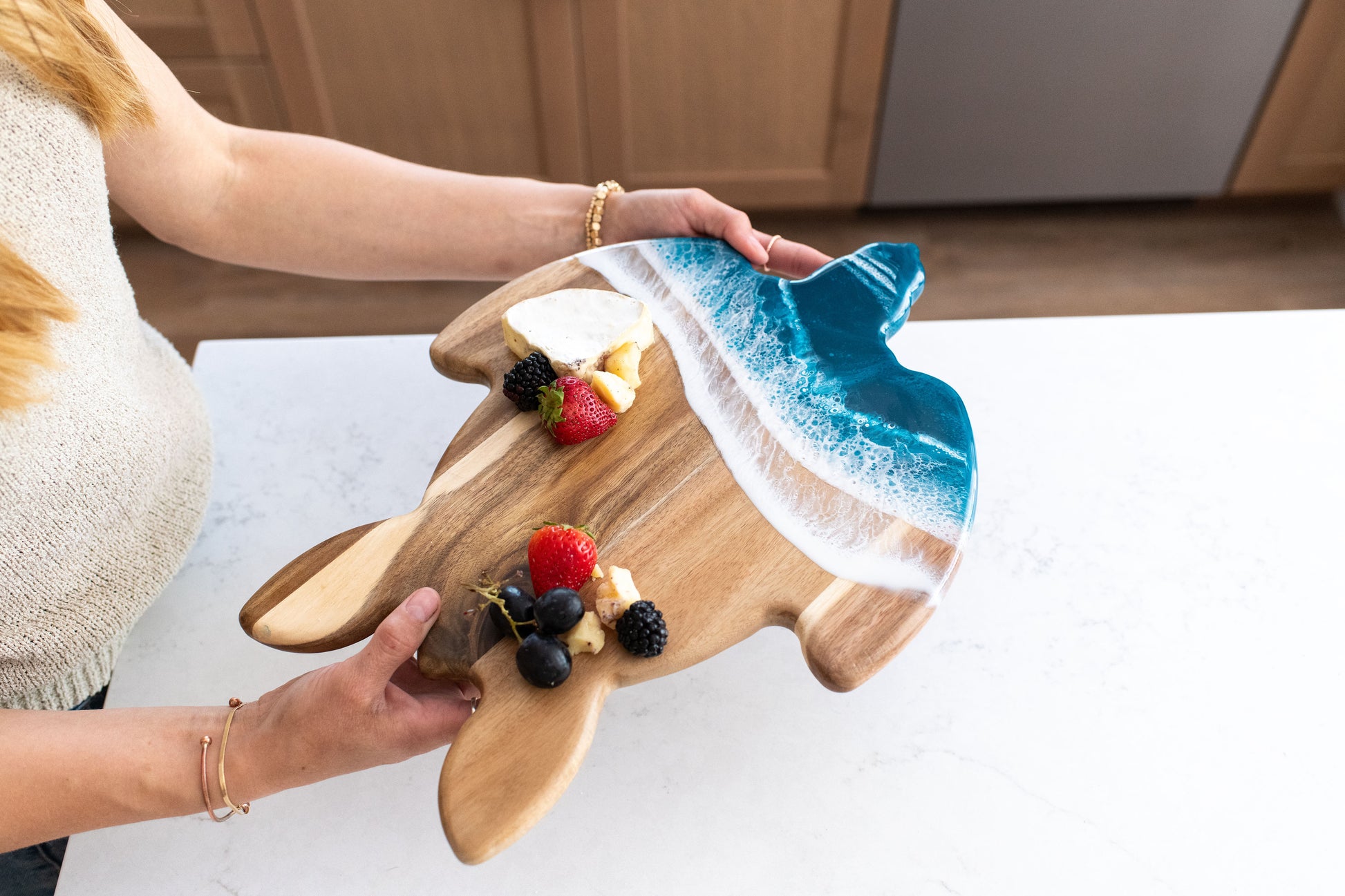 Hands holding ocean vibes turtle board 