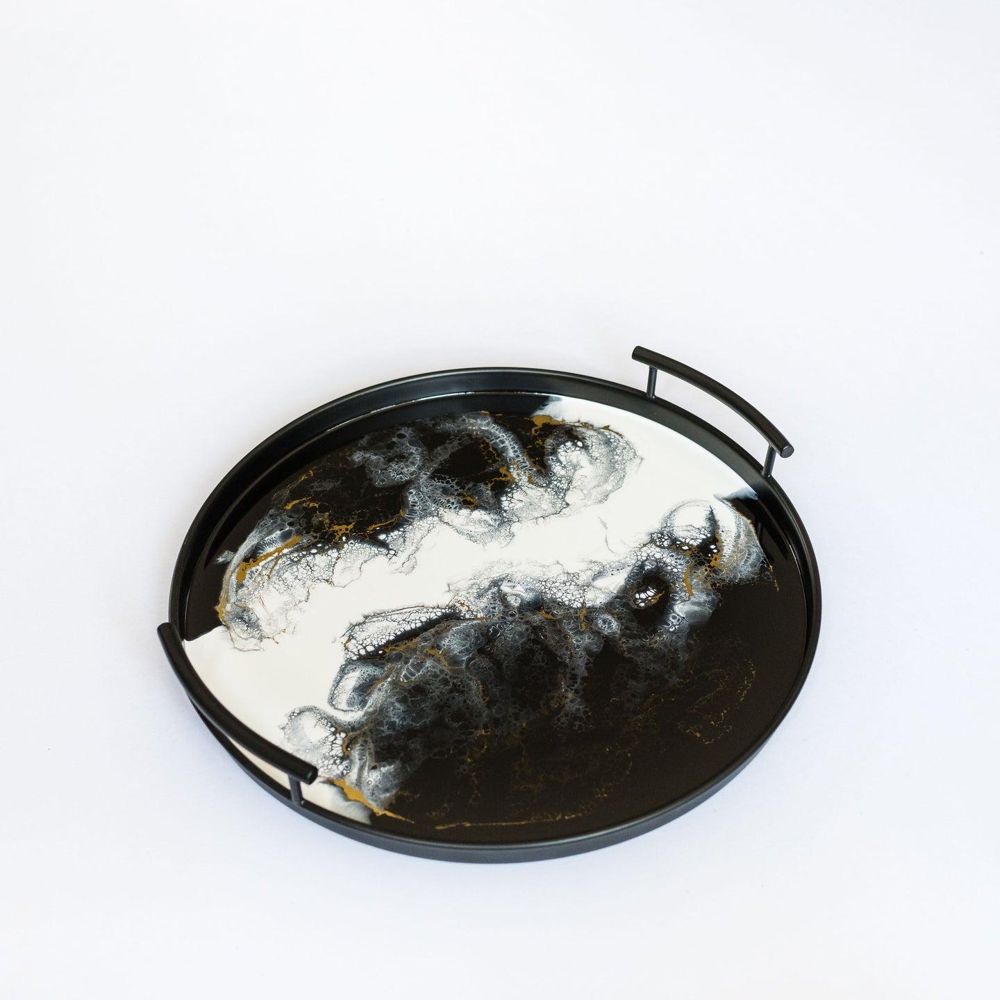 black round metal tray accented with resin