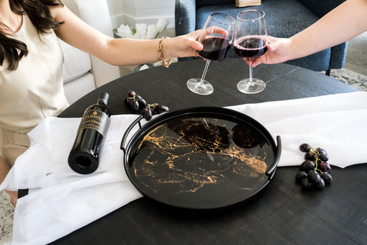 black round metal tray accented with resin