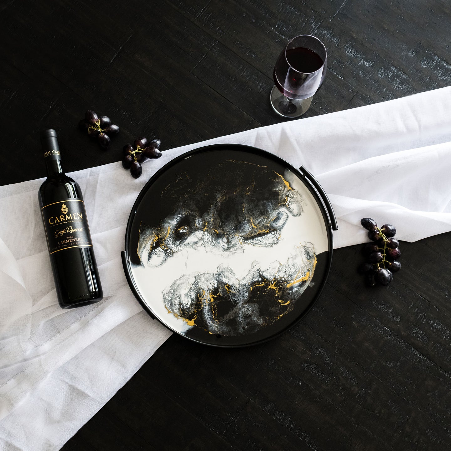 black round metal tray accented with resin