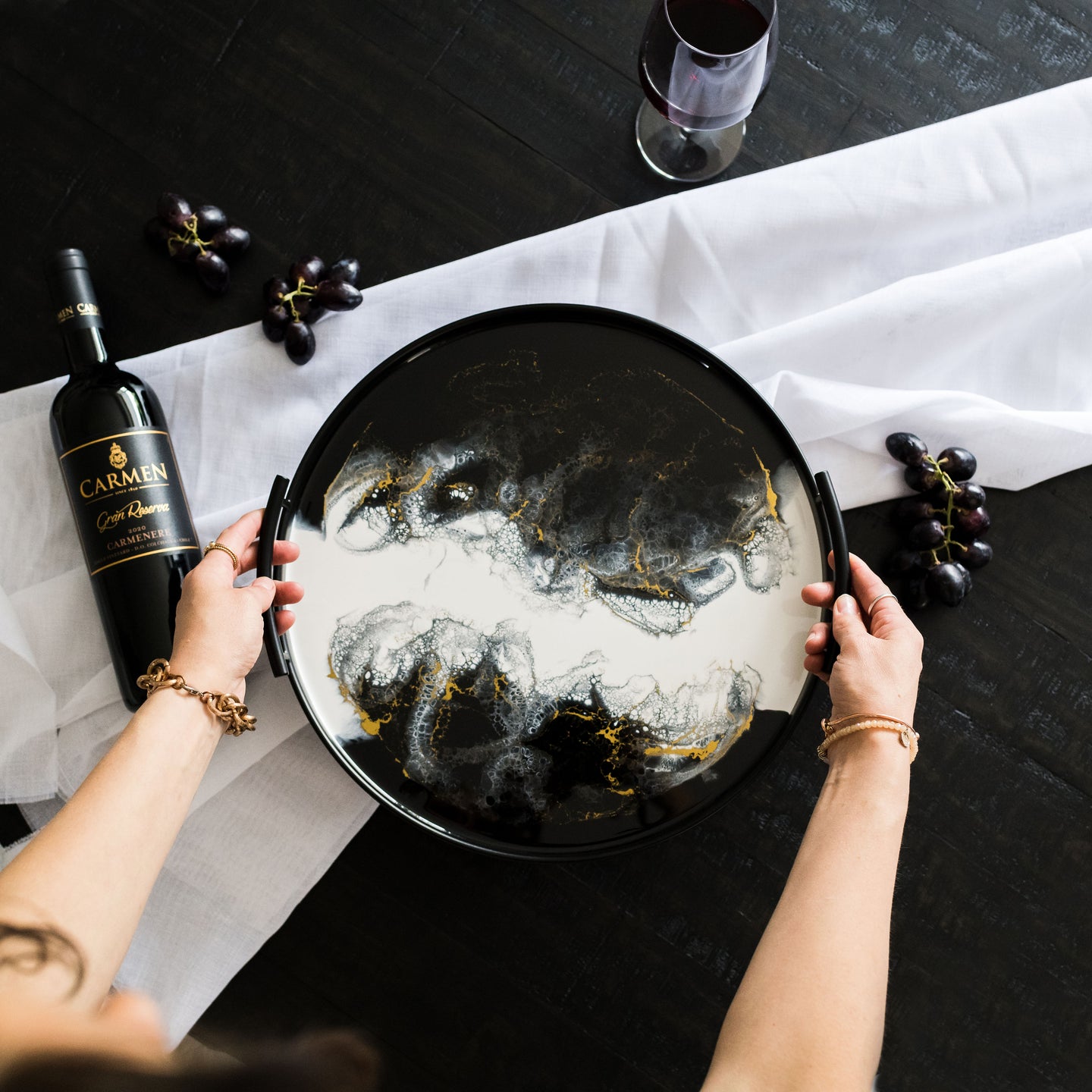 black round metal tray accented with resin