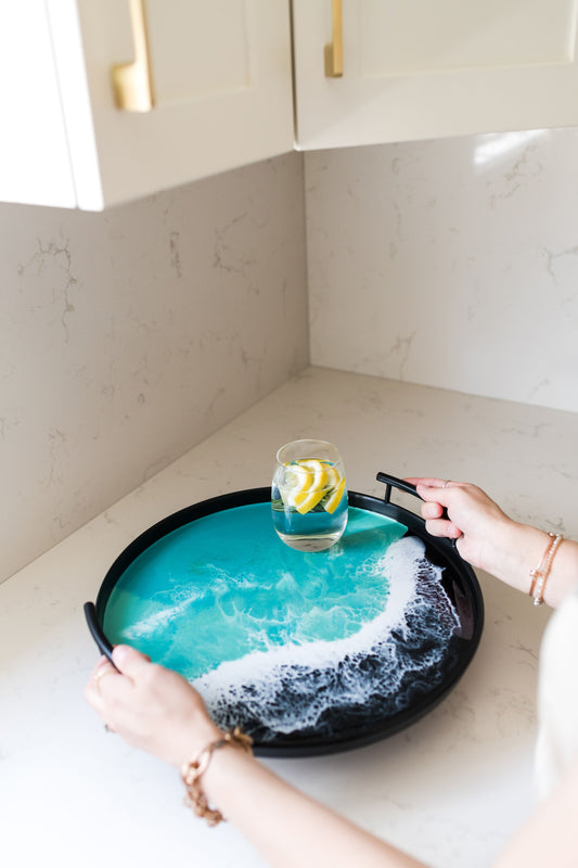 black round metal tray accented with resin