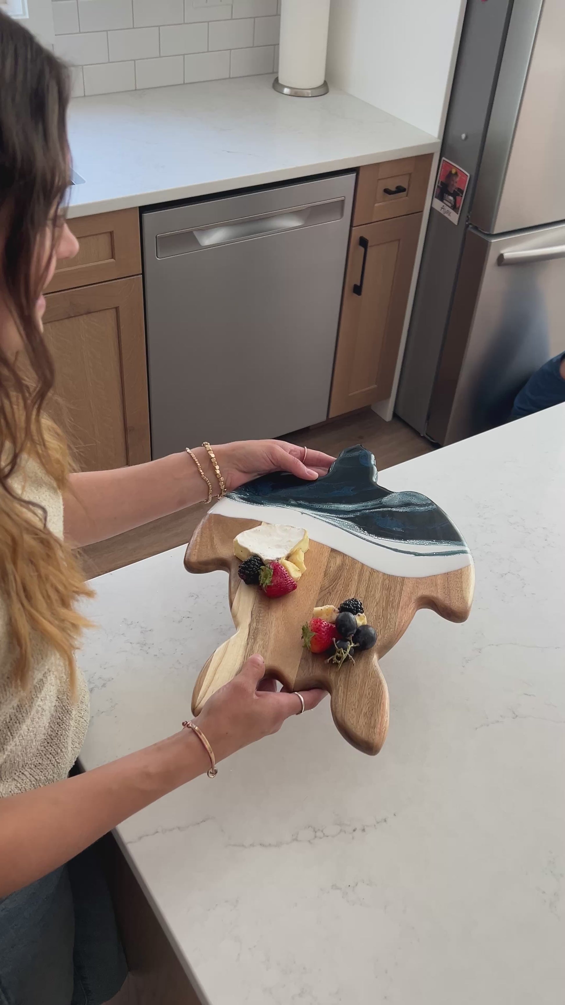 video of a women holding the navy white turtle board 