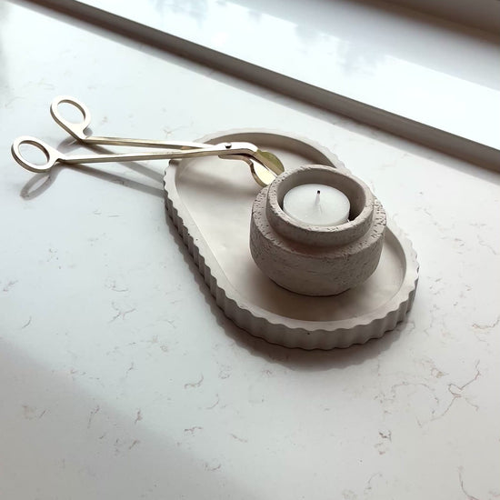 video of our limestone oval tray and candle holder as a set on a marble countertop 