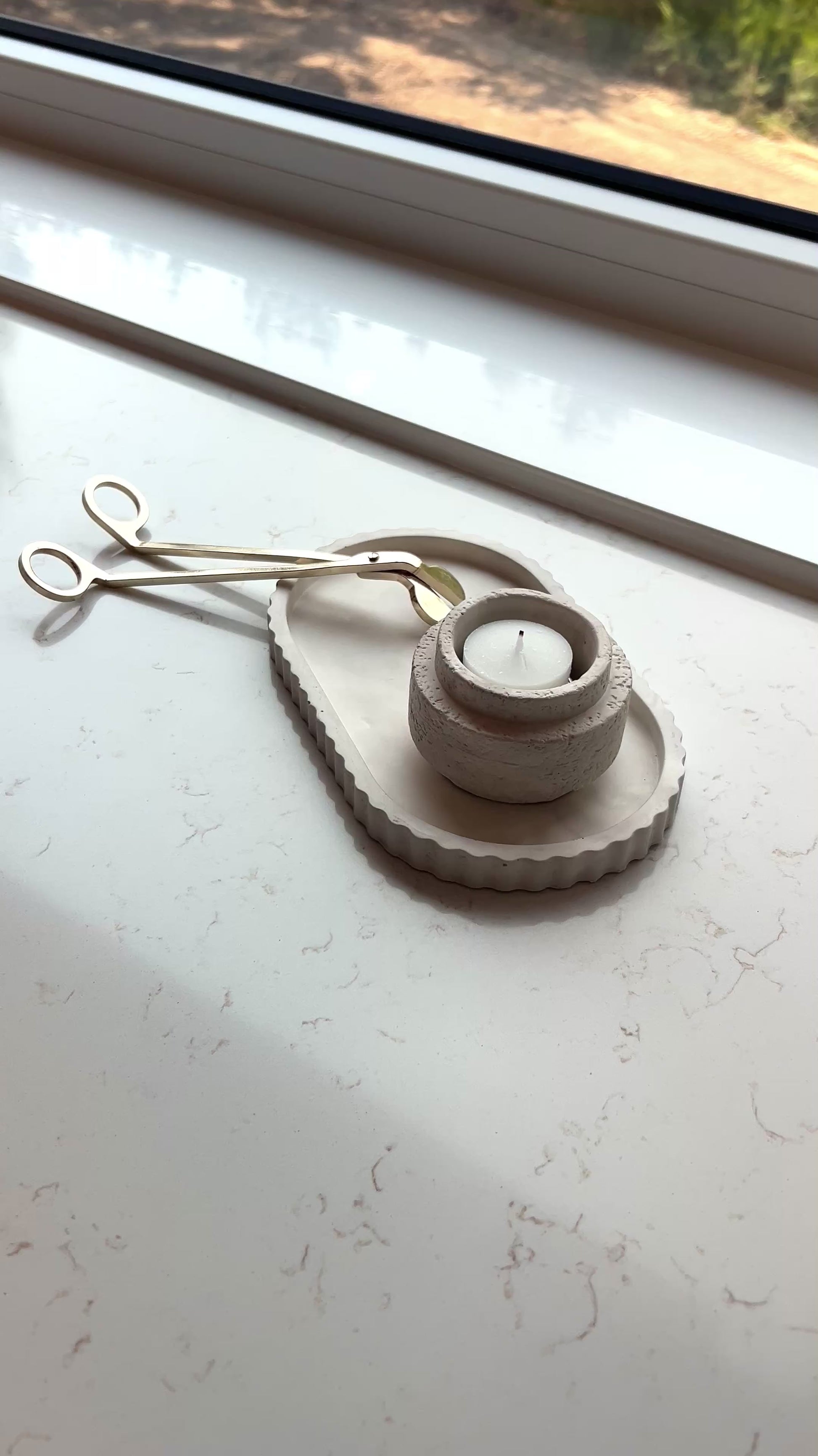 video of our limestone oval tray and candle holder as a set on a marble countertop 