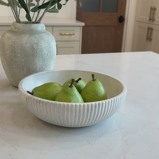 video of our limestone bowl in the kitchen with three pears in it 
