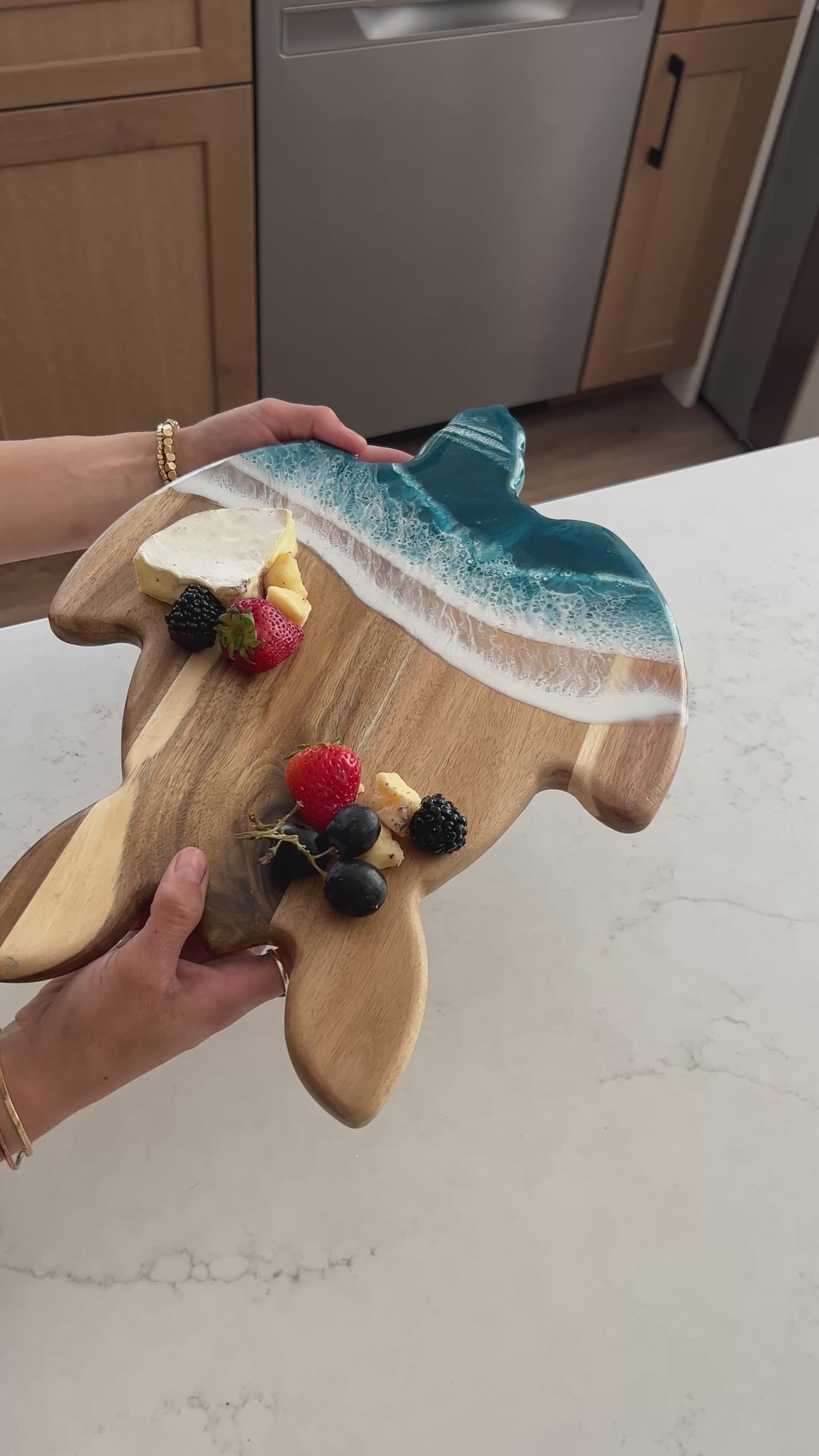 video of a women holding the ocean vibes turtle board 