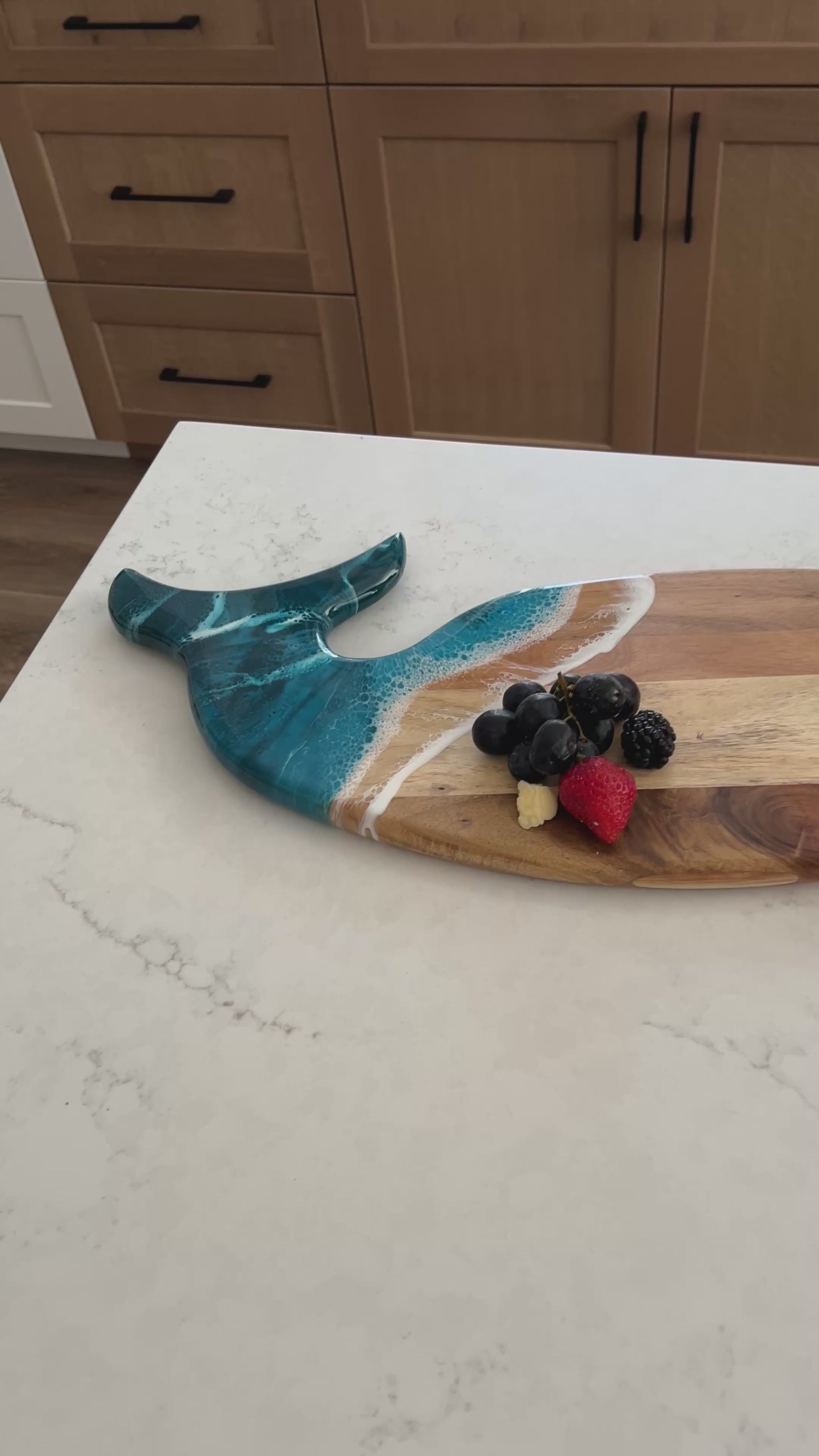 video of the ocean vibes whale board and matching ceramic tray on a kitchen counter 
