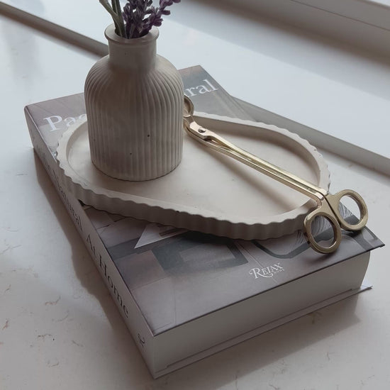 video of our limestone oval tray and bud vase on a stack of books 