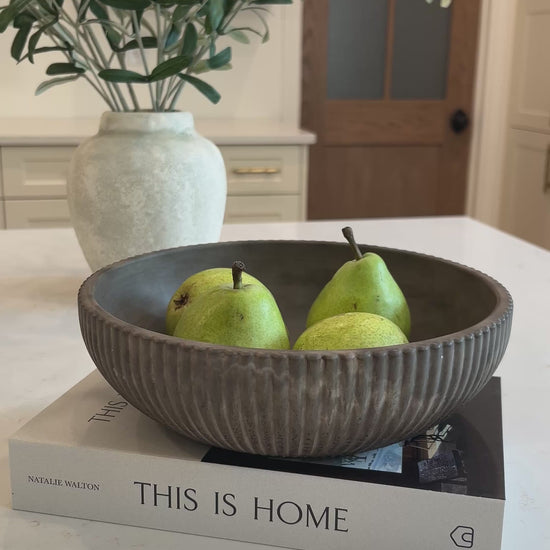 video of the mocha stone bowl on a decorative book in the kitchen 