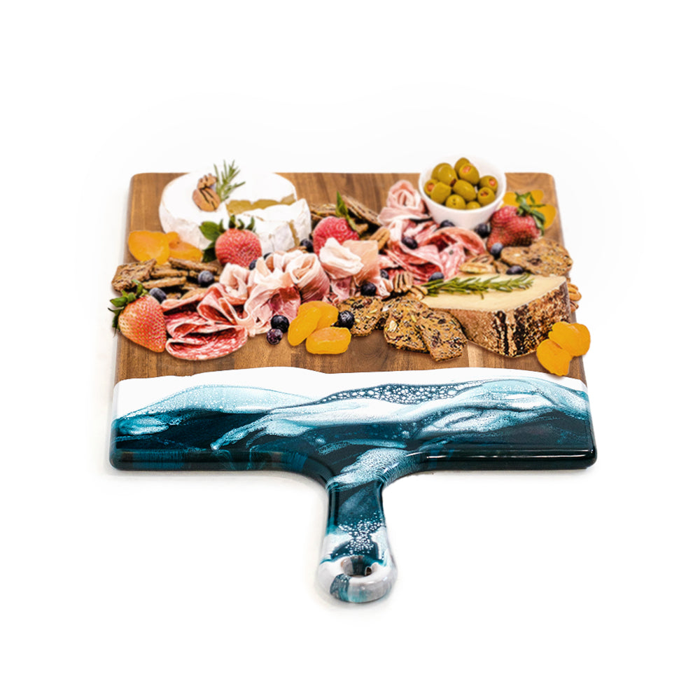 Extra Large Acacia cheese board with Navy Blue and white Epoxy Resin accent handle with charcuterie laid out on it